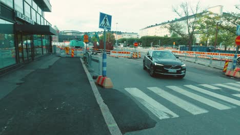 Construction-Roadworks-Zebra-Crossing-in-Helsinki,-Finland-with-Passing-Vehicle