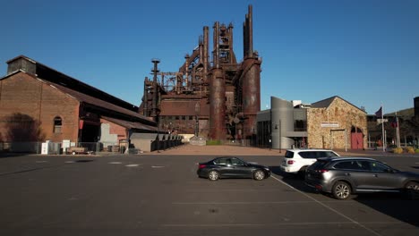 A-low-angle,-drone-view-of-the-parking-lot-of-the-Bethlehem-Steel-stacks-in-PA-on-a-sunny-day