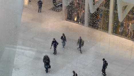 Raindrops-Falling-Down-Skylight-Window-At-World-Trade-Centre-Station-In-New-York-With-View-Of-People-Walking-Below