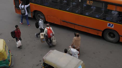 People-walking-through-busy-traffic,-Delhi-India