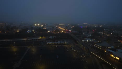 Aerial-view-toward-the-cityscape-of-Santa-Monica,-foggy-evening-in-Los-Angeles,-USA
