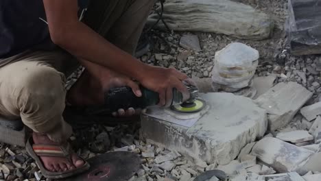 Workers-smooth-the-surface-of-stones-with-a-grinder