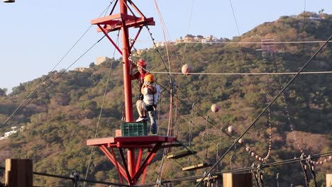 Excited-young-girl-jumping-down-a-zip-line-in-Mexico