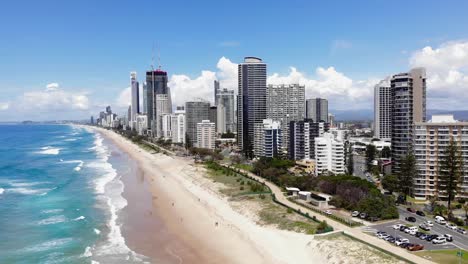 Surfers-Paradise,-Queensland-Australia---February-28-2021:-Aerial-of-Surfers-Paradise-looking-north-and-swimmers-in-the-waves