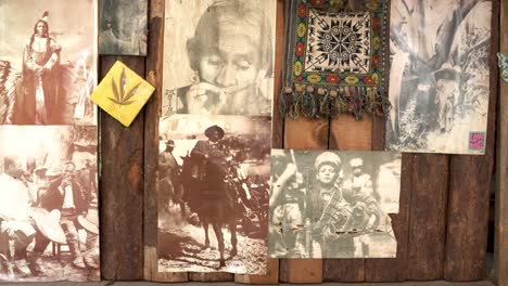Vintage-photographs-including-Pancho-Villa-and-a-cannabis-plant-drawing-on-a-wall-at-a-cabin,-Dolly-in-shot