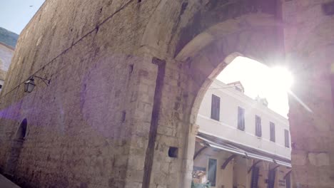 Dubrovnik,-the-sun-shining-through-the-gate-in-the-walls-of-the-old-town