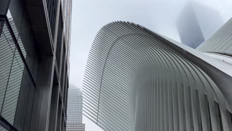 Panning-Shot-View-Of-The-Oculus-Transportation-Hub-At-World-Trade-Center-In-New-York-On-A-Rainy-Day