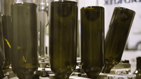 Empty-wine-bottles-getting-washed-in-industrial-bottling-facility