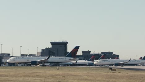 Wide-shot-of-ATL-airport-in-Atlanta,-Georgia-Delta-Terminal-as-commercial-airplanes-taxi-into-their-gates