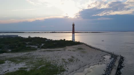 A-4K-drone-shot-of-the-Barnegat-Lighthouse,-located-on-the-northern-tip-of-Long-Beach-Island-in-Ocean-County,-New-Jersey,-U