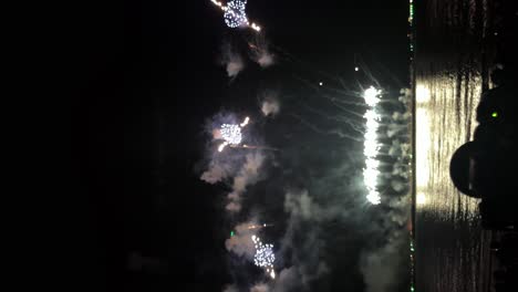 Detail-of-screen-capture-recording-of-camera-filming-large-fireworks-festival-near-the-seafront---vertical-video
