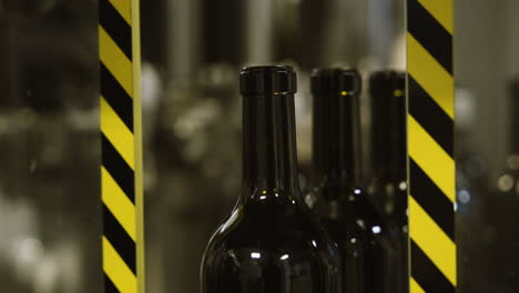 Wine-bottles-on-a-conveyor-belt-in-an-industrial-environment