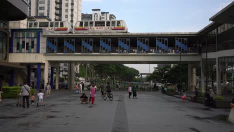 Scene-of-the-LRT-train-arriving-at-the-station-and-people-commuting-outside-Bukit-Panjang-MRT-Station-,-Singapore