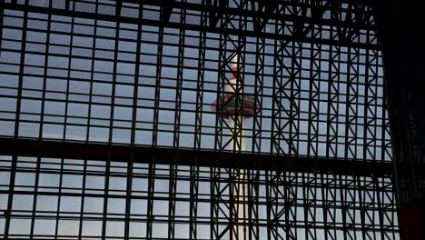 Kyoto-Tower-Viewed-From-Inside-Kyoto-Station-Through-Building-Window-Framework-Structure