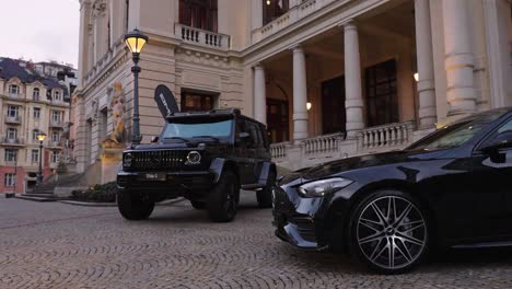 Reveal-of-black-shiny-Mercedes-cars-parked-at-luxurious-villa-driveway