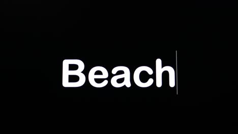 Typing-on-a-dark-background-with-the-word-Beach