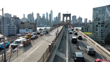 Aerial-flight-over-traffic-and-pedestrians-on-Brooklyn-Bridge-in-New-York-City