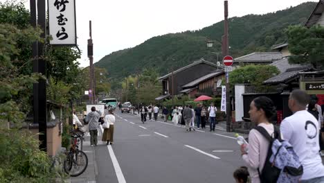 Japanese-People-and-tourists-walking-Street-in-Prefectural-Road-29-in-Arashiyama,-Kyoto-Japan