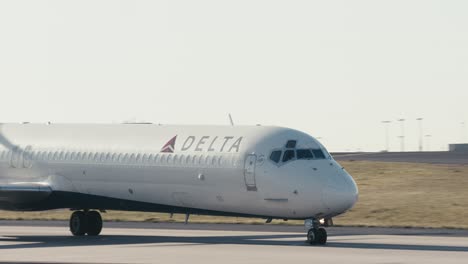 Medium-shot-of-a-Delta-commercial-airplane-taxing-down-a-runway-at-ATL-airport-in-Atlanta-Georgia