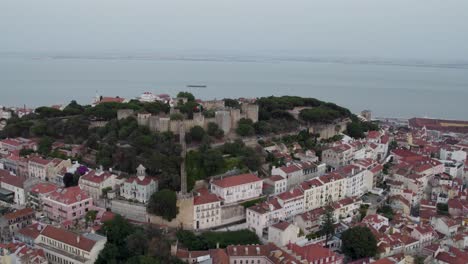 A-4K-drone-shot-of-Saint-George's-Castle,-a-11th-century-hilltop-Royal-Castle-and-museum-in-Lisbon,-Portugal