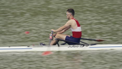 A-camera-follows-a-fast-rower-on-a-single-scull-during-a-race