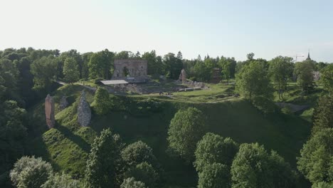 drone-flight-over-the-castle-ruins-on-top-of-the-hill-showing-greenery-in-the-Viljandi-City-in-Estonia