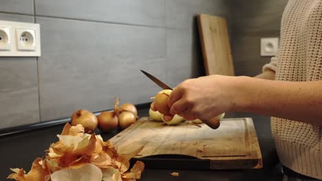 Kitchen-Scene:-Woman-Peeling-Onions-on-Wooden-Board