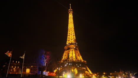 View-from-vehicle-of-glowing-Eiffel-Tower-at-night