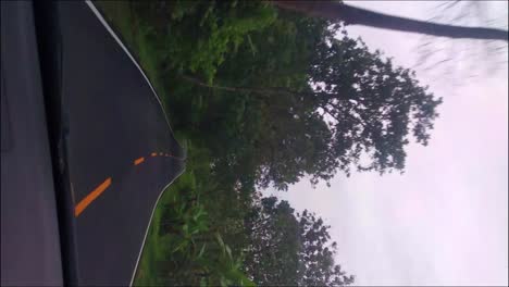 The-view-from-the-dashboard-of-the-car-passes-through-winding-rural-roads-in-the-southern-route-of-Garut,-West-Java
