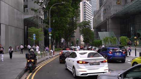 Morning-scene-of-the-street-with-slow-moving-traffic-in-the-Central-Business-District,-Raffles-Place,-Singapore