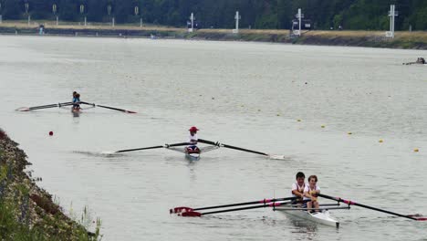 Rowers-in-double-sculls-sail-slowly-to-the-start-of-the-race-at-the-water-sports-complex