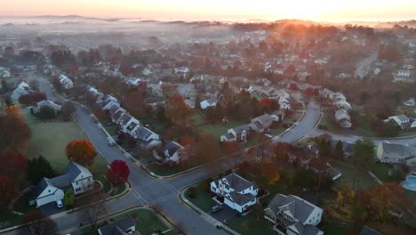 American-neighborhood-with-fog-over-two-story-homes-during-autumn-sunrise