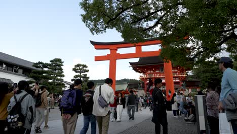 Busy-Crowds-Walking-Towards-Second-Torii-Gate-And-Entrance-Tower-Gate-Entrance-To-Fushimi-Inari-Taisha-In-Kyoto