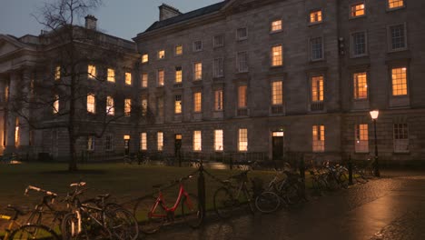 Bicycles-On-The-Chain-Link-Fence-Outside-The-Trinity-College-At-Night-In-Dublin,-Ireland