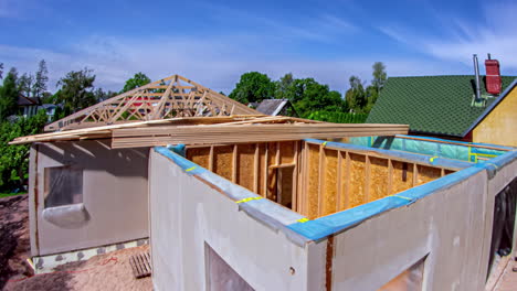 Time-lapse-of-construction-of-a-wooden-roof-frame-on-a-neighborhood-house
