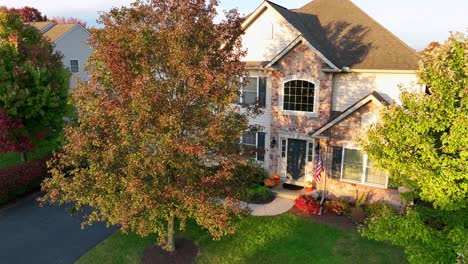 Suburban-home-with-fall-foliage-and-American-flag-display