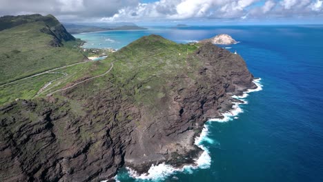 Hawaii's-coastal-landscape-captivates-with-its-perilous-beauty,-featuring-towering-white-waves-and-volcanic-rock