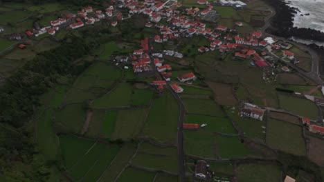 Tilt-up-shot-of-small-town-at-Azores-islands-Portugal,-aerial