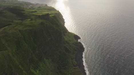 Reveal-shot-of-coastline-high-cliff-at-Flores-island-Azores---Drone-shot