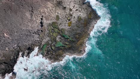 The-perilous-beauty-of-Hawaii's-coast,-characterized-by-towering-white-waves-and-volcanic-rock