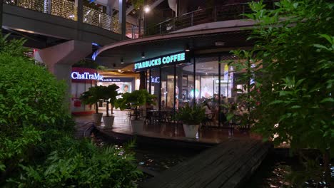 Front-view-of-a-popular-coffee-shop-and-tea-café-at-a-community-mall-in-Bangkok,-Thailand
