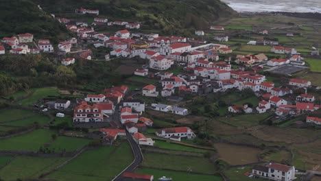 Aerial-telephoto-shot-of-small-town-at-Flores-island-Azores-at-Sunset