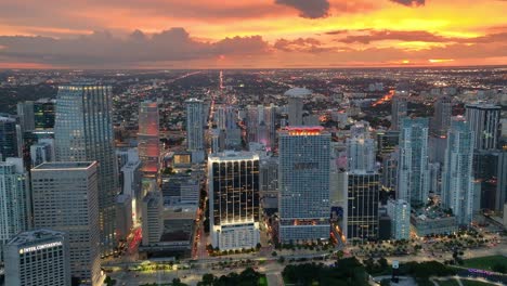 Miami-sparkles-at-evening,-presenting-a-dynamic-aerial-view-with-landmark-buildings-and-avenue-traffic