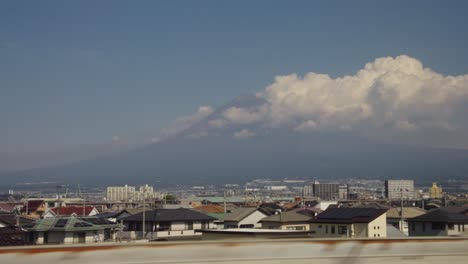Mt-Fuji-Passing-by-in-Background-seen-from-Seat-on-Bullet-Train-to-Tokyo