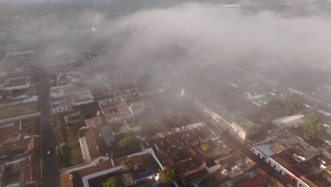 Aerial-view-of-Santa-Catalina-arch-in-Antigua-city-Guatemala-foggy-sunrise
