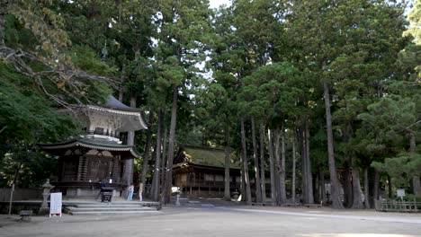 Tourists-Seen-Beside-Rokkaku-Kyozo-,-a-large-prayer-wheel-in-Danjo-Garan-Temple-Complex,-the-center-of-Koyasan