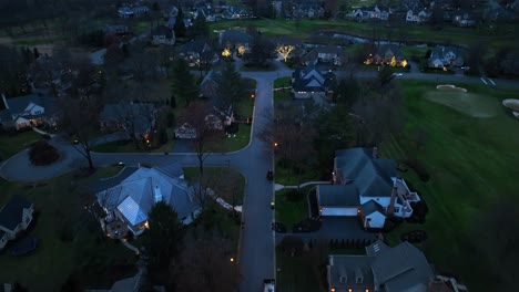Twilight-over-a-quiet-residential-neighborhood-with-streetlights-aglow