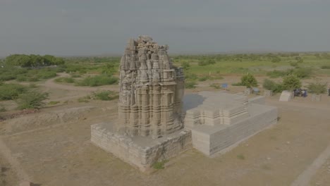 Aerial-drone-footage-records-the-Jain-Temple-in-Nagarparkar,-Pakistan,-under-sunny-skies-and-clear-weather
