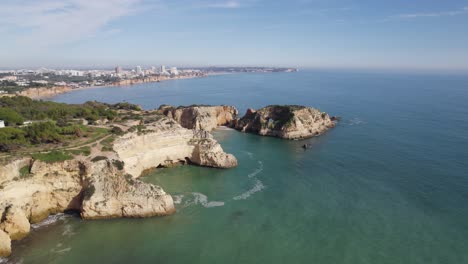 Aerial-view-of-the-beautiful-Portimão-coastline,-Limestone-cliffs-and-Rock-formations,-Portugal
