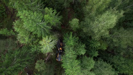 Aerial-shot-of-Scandinavian-finnish-forest-and-forestry-machine-Ponsse-Scorpion-harvester-filmed-with-DJI-Air-2s